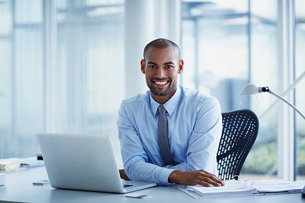 portrait of happy businessman at desk - business blue business person businessman ストックフォトと画像