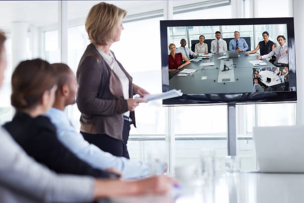 Businesswoman giving presentation Businesswoman giving presentation in conference meeting conference call stock pictures, royalty-free photos & images