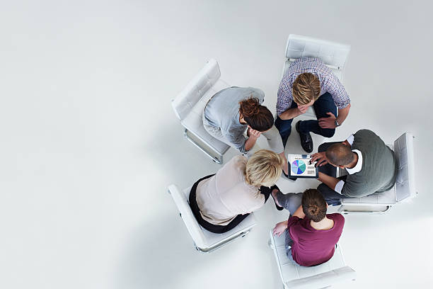 business planning work images Businesspeople using digital tablet together High angle view of businesspeople using digital tablet together in office business plan stock pictures, royalty-free photos & images