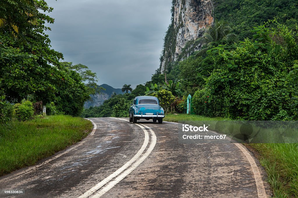 American oldtimer drive on Cuban road American oldtimer drive lonely on Cuban road 2015 Stock Photo