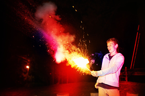 Cropped shot of a teenage boy playing with a fireworkhttp://195.154.178.81/DATA/i_collage/pi/shoots/783371.jpg