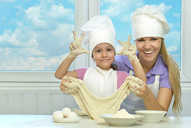istock Mother and daughter cooking together 498332836