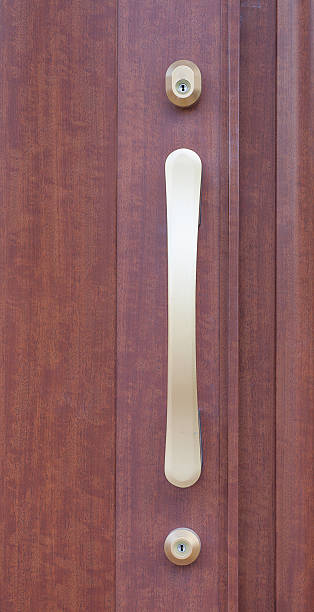 istock Modern door handle and brown wood door 498332894