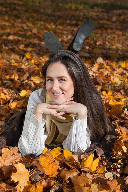 istock Smiling woman among autumn leaves. 498332932