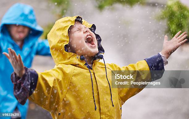 They Love The Rain Stock Photo - Download Image Now - Child, Rain, Playing