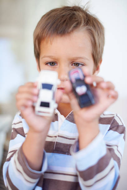 Portrait of a little boy playing with toy carshttp://195.154.178.81/DATA/i_collage/pi/shoots/783419.jpg