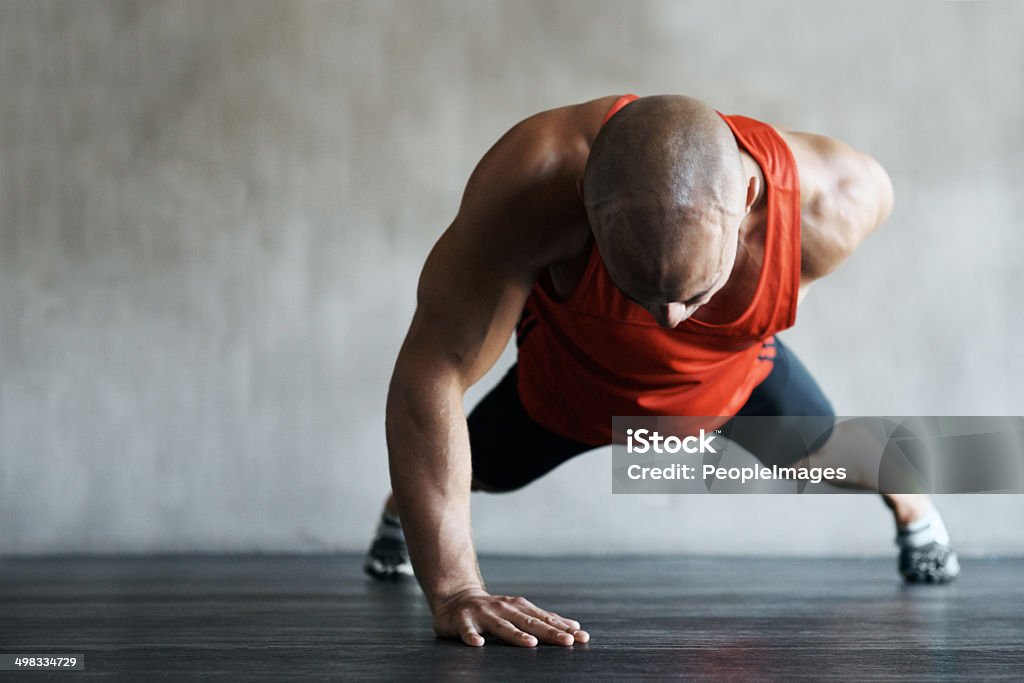 Pushing past the boundaries of endurance Shot of a handsome young man working out in the gymhttp://195.154.178.81/DATA/i_collage/pi/shoots/783431.jpg Determination Stock Photo