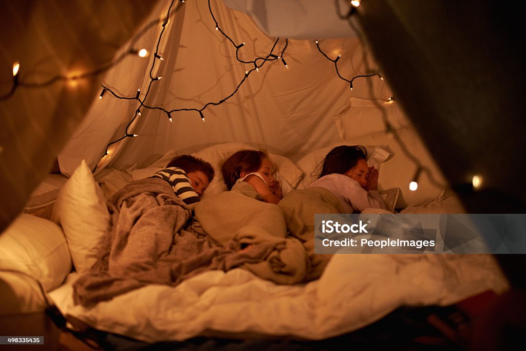 Sleeping in our imaginary tent Shot of three young children sleeping in blanket tenthttp://195.154.178.81/DATA/i_collage/pi/shoots/783447.jpg Slumber Party Stock Photo