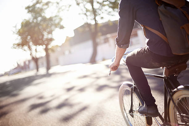 Whiling away the miles A young man riding a bicycle outdoorshttp://195.154.178.81/DATA/i_collage/pi/shoots/783453.jpg hipster bike stock pictures, royalty-free photos & images