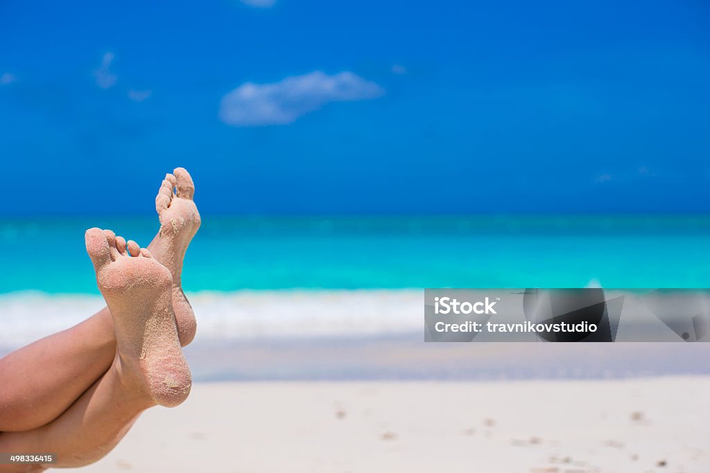 Close up of female feet on white sandy beach Close up of female feet on white sand beach Adult Stock Photo