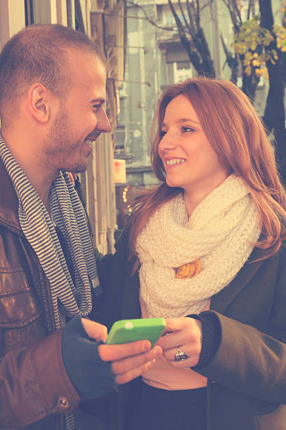 istock Couple in love using cellphone outdoors. 498336584
