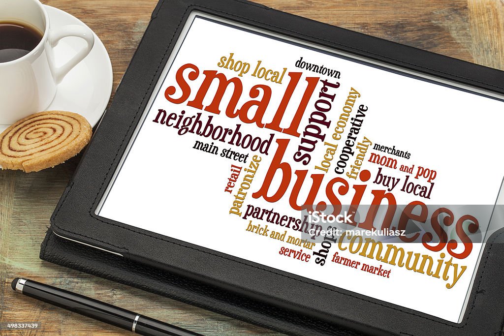 small business word cloud small business word cloud on a digital tablet with a cup of coffee Small Business Stock Photo