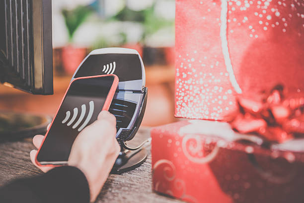 istock Woman Paying With NFC Technology on Smart Phone in Store 498338152