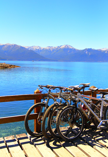 Bikes in a wooden pier at Lake Nahuel Huapi to Arryanes Park, Vila La Angostura, Patagonia, Argentina   