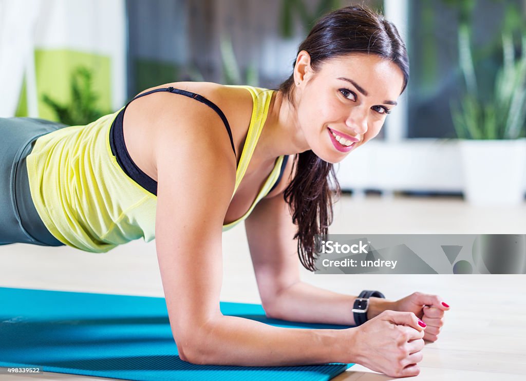 portrait fitness training athletic sporty woman doing plank exercise in portrait fitness training athletic sporty woman doing plank exercise in gym or yoga class concept exercising workout aerobic. 2015 Stock Photo