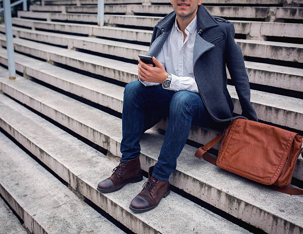 istock Young man holds a smart phone in hand 498339568