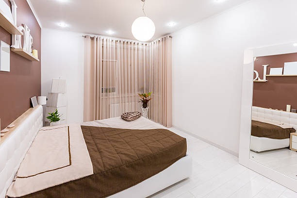 istock Modern minimalism style bedroom interior in light warm tones 498342802