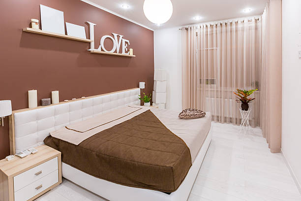istock Modern minimalism style bedroom interior in light warm tones 498342828
