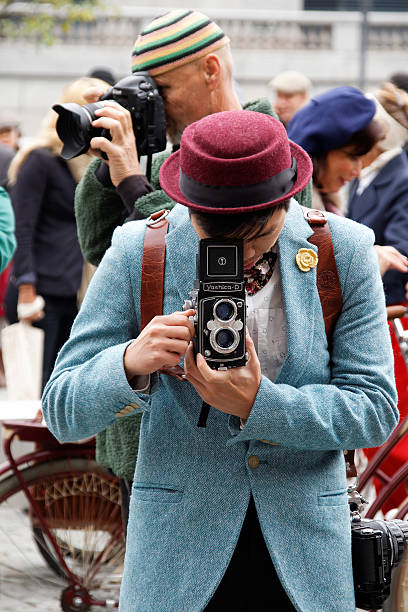 Stockholm, Sweden - September 19, 2015: Photographer in blue tweed jacket  with retro camera in the Bike in Tweed event September 19, 2015 in Stockholm, Sweden