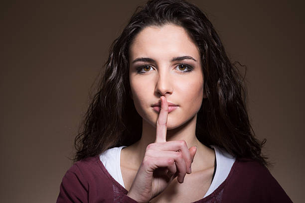 istock Beautiful girl making silence gesture 498344336