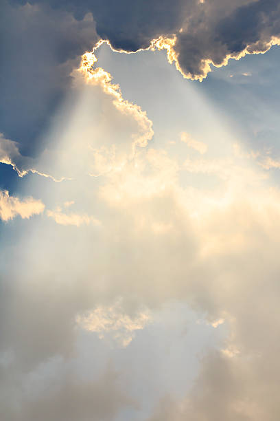 Clouds and sun beams on evening time stock photo