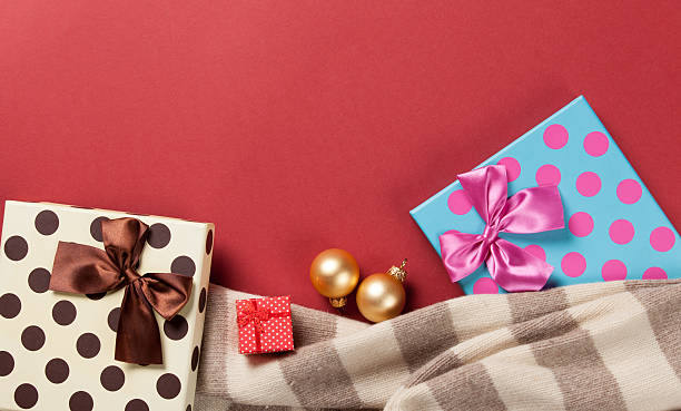 Scarf and christmas gifts on blue background