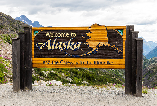 The Welcome to Alaska and the Gateway to the Klondlike sign in Alaska, America in the cloudy day