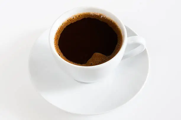 Photo of natural black coffee in a white cup