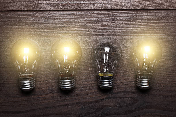 istock glowing bulbs weak link concept on wooden background 498361425