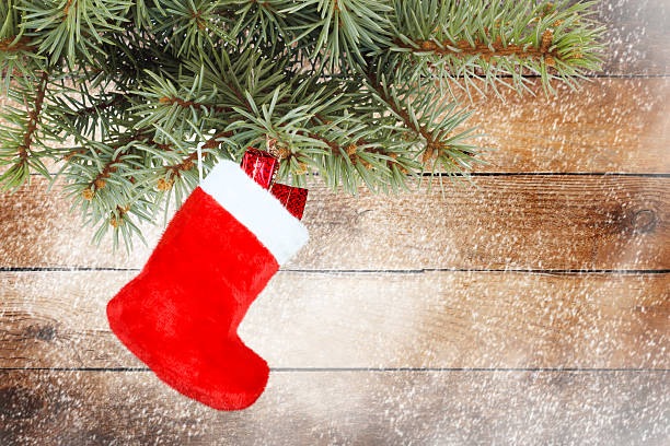 istock Red christmas boot with gifts on background wooden wall 498362441