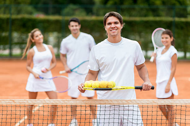 istock Man giving tennis lessons 498364673