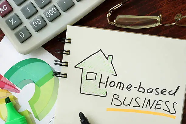 Photo of Notepad with Home-based business on the wooden table.