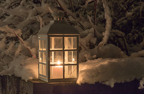 Lantern with a candle and snowy branches stock photo