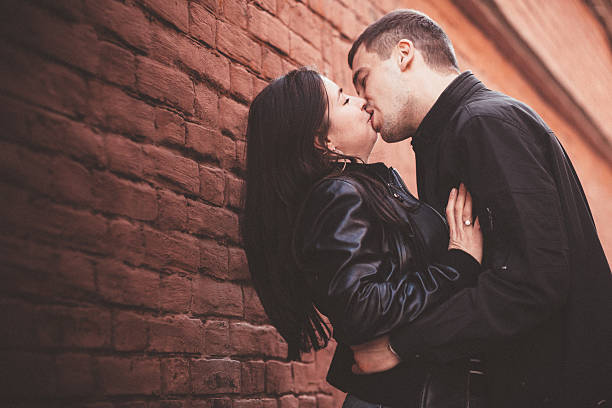 istock loving couple near the wall 498368540