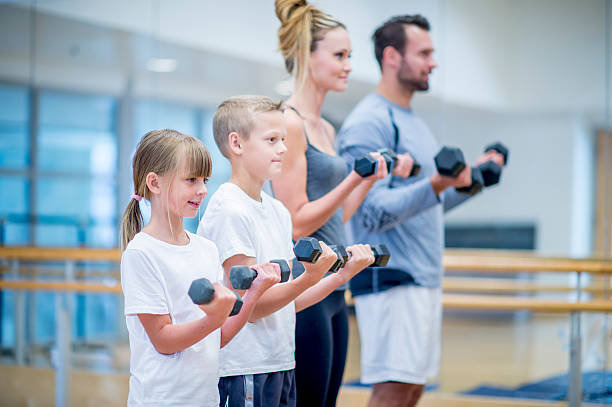 istock Family Lifting Weights Together 498368690