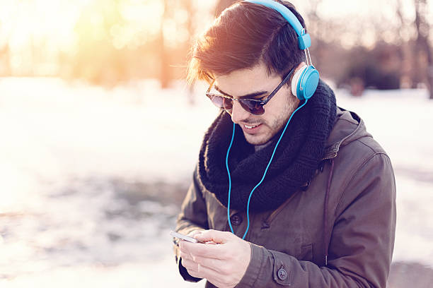 istock Man texting in the winter park 498370188