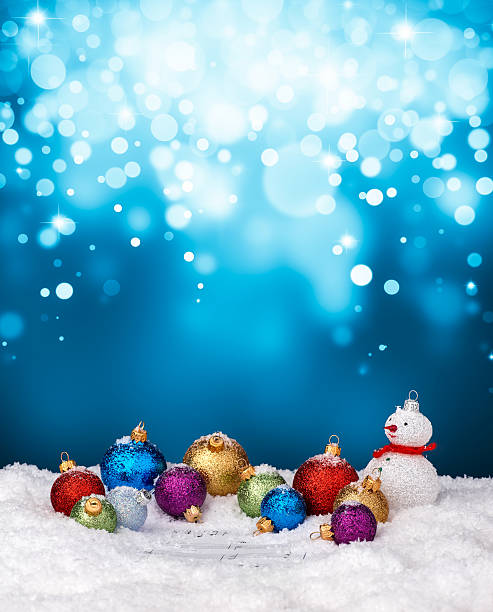 istock Snowman and multicolor baubles on snow 498370236