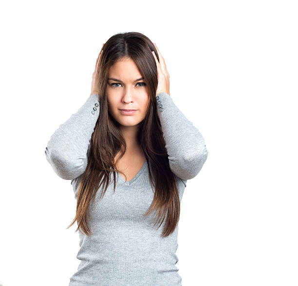 istock Woman holding hands on head 498373158