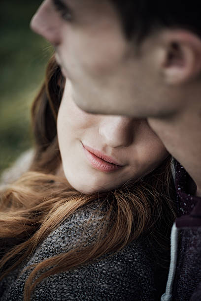 istock Young loving couple relaxing on the grass 498376080