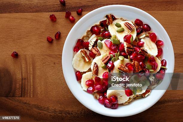 Bowl Of Breakfast Oatmeal With Pomegranate Bananas Seeds And Nuts Stock Photo - Download Image Now