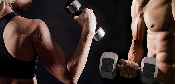 istock Man and woman abs arm curling 498377436