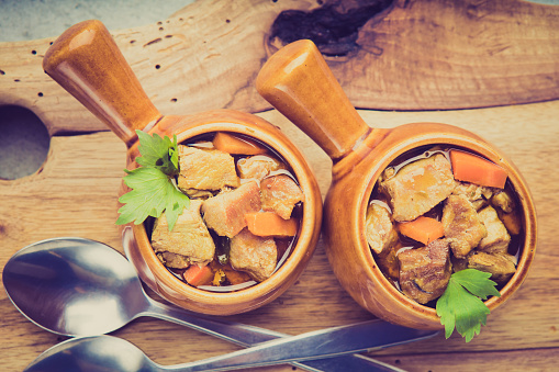 Vintage photo of portion of traditional beef stew with carrots