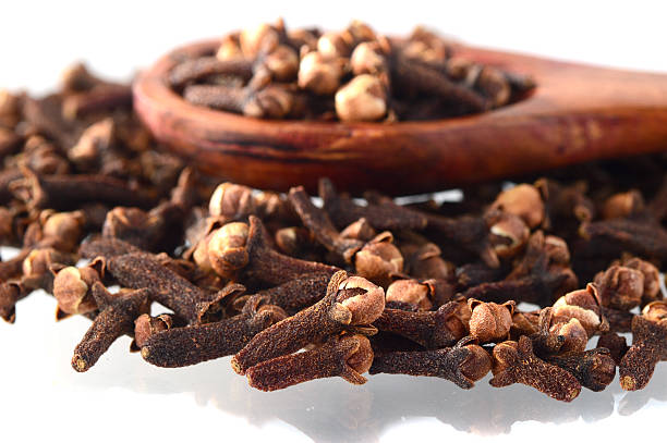 istock clove in spoon isolated on a white background 498380654