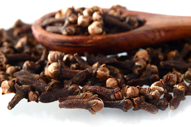 istock clove in spoon isolated on a white background 498380926