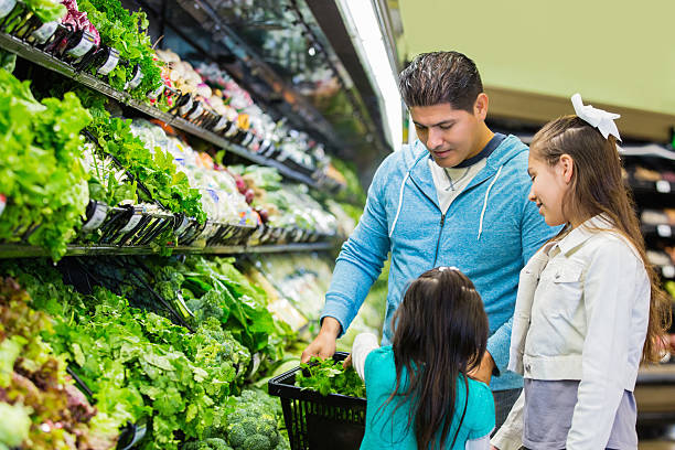 istock Customer shopping in supermarket with his young daughters 498380964