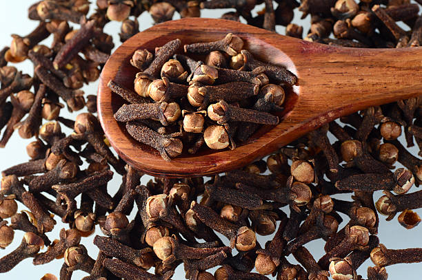 istock clove in spoon isolated on a white background 498381264