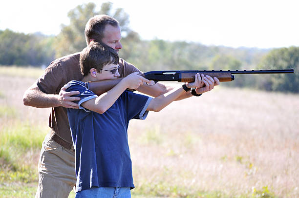 istock Father Instructing his Son on Proper Gun Safety 498385135