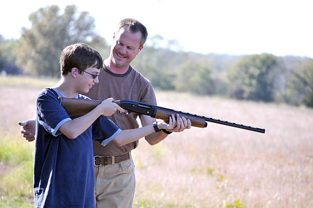istock Father Instructing his Son on Proper Gun Safety 498385137