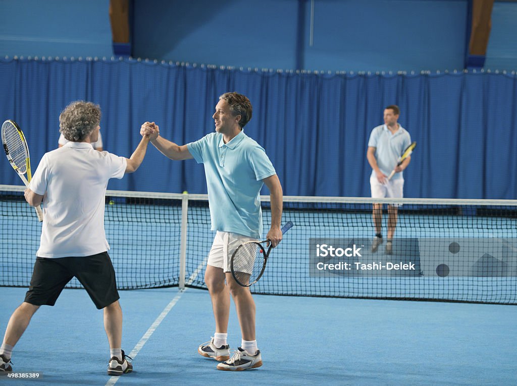 Doubles Match Four people playing a double match. Activity Stock Photo