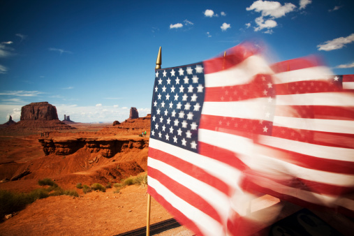 usa flags against monument valley panorama